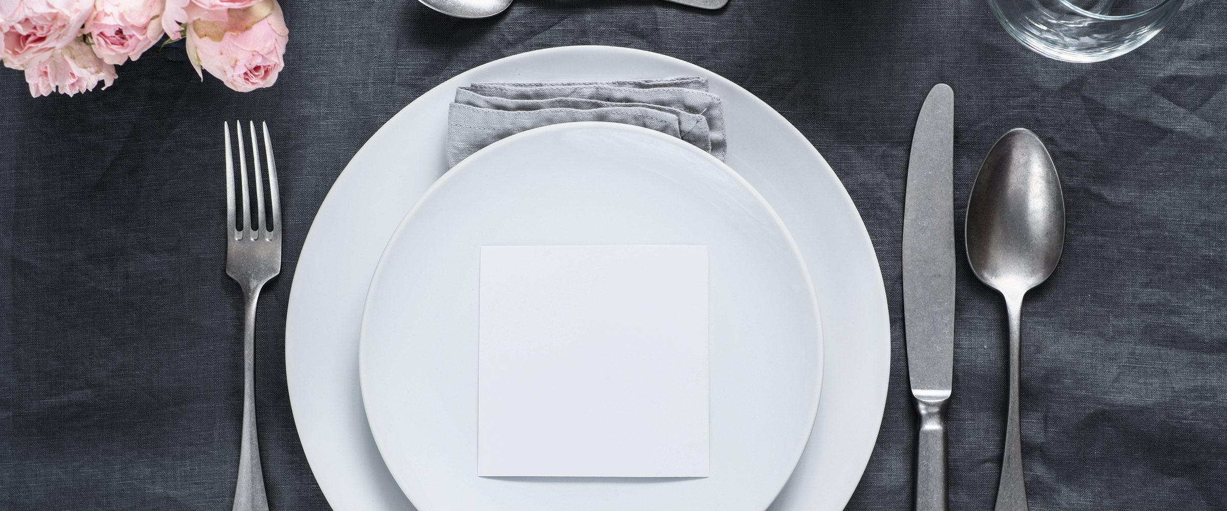 Menu, wedding invitation mock up. Beautiful table setting on gray linen tablecloth. Festive table setting for wedding dinner with pink spray roses and cabdle. H