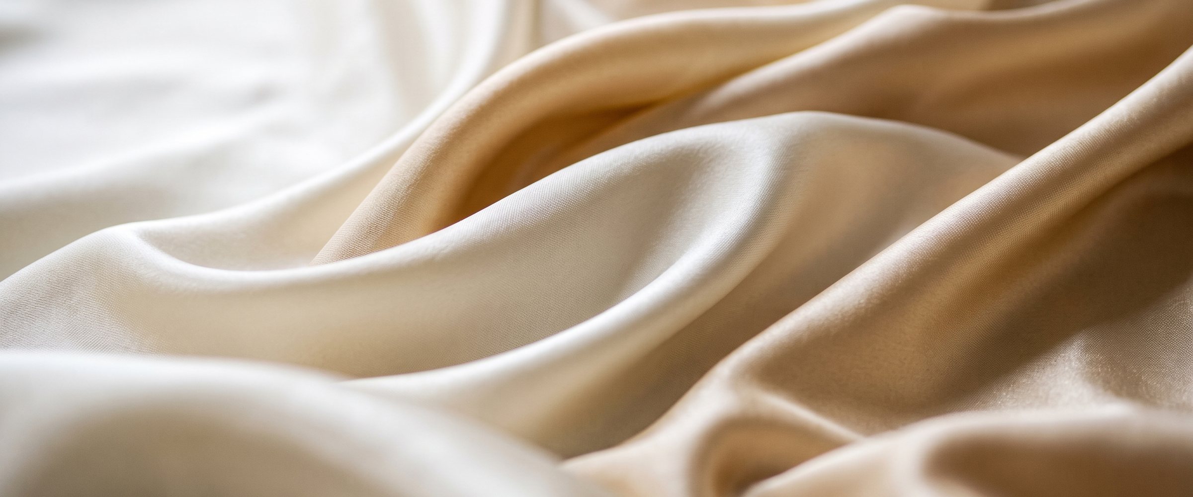 Premium white silk satin fabric waves texture, smooth elegant flowing cloth backdrop