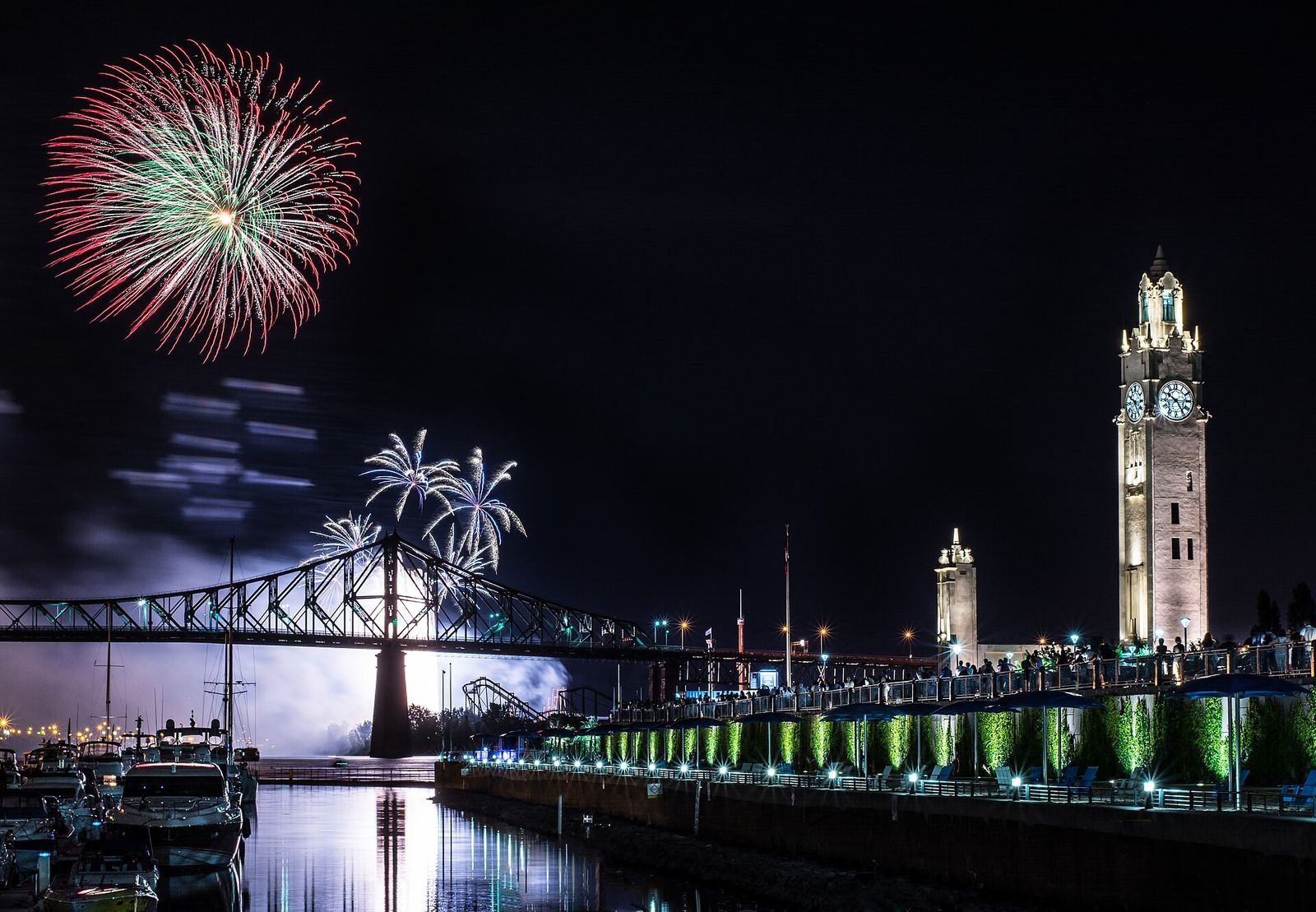 View of the Clock Tower, located on the headpier of Quai de l'horloge, in Montreal's Old Port, during a fireworks display