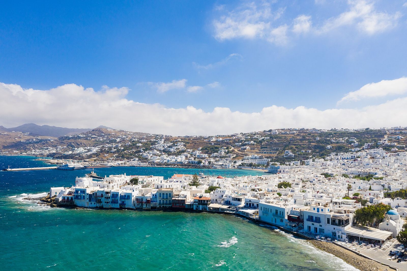 Little Venice with a view of the ferry terminal in Mykonos, Greece