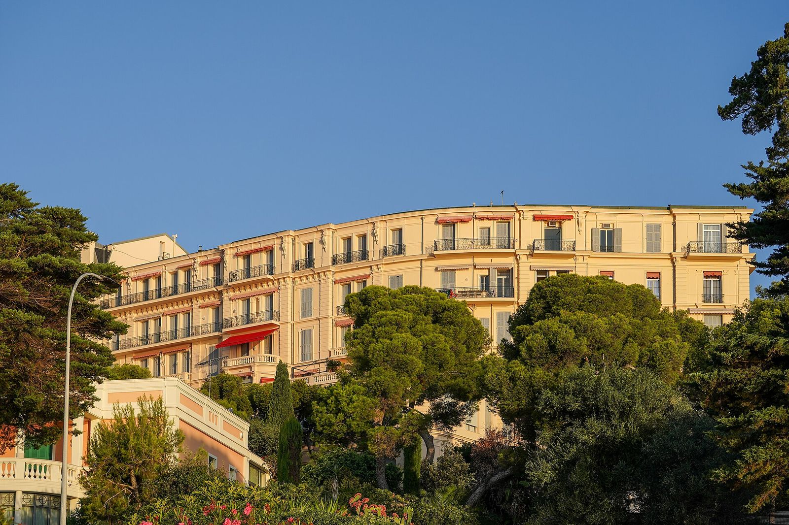 Former Grand Hotel du Cap, built 1890, east wing seaward facade from the Le Corbusier footpath at Pointe du Cap Martin, amfAR Gala Cannes