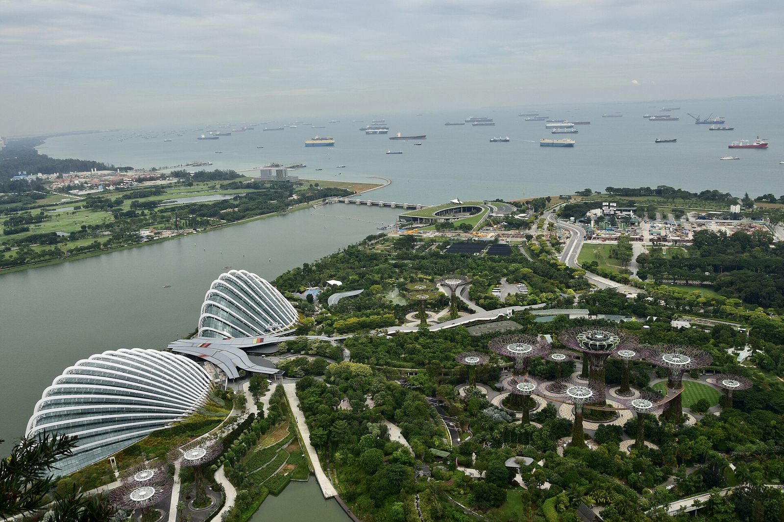 A view of the Gardens by the Bay nature park, outer harbor and ships from the 57 floor of Marina Bay Sands in Singapore, ART SG