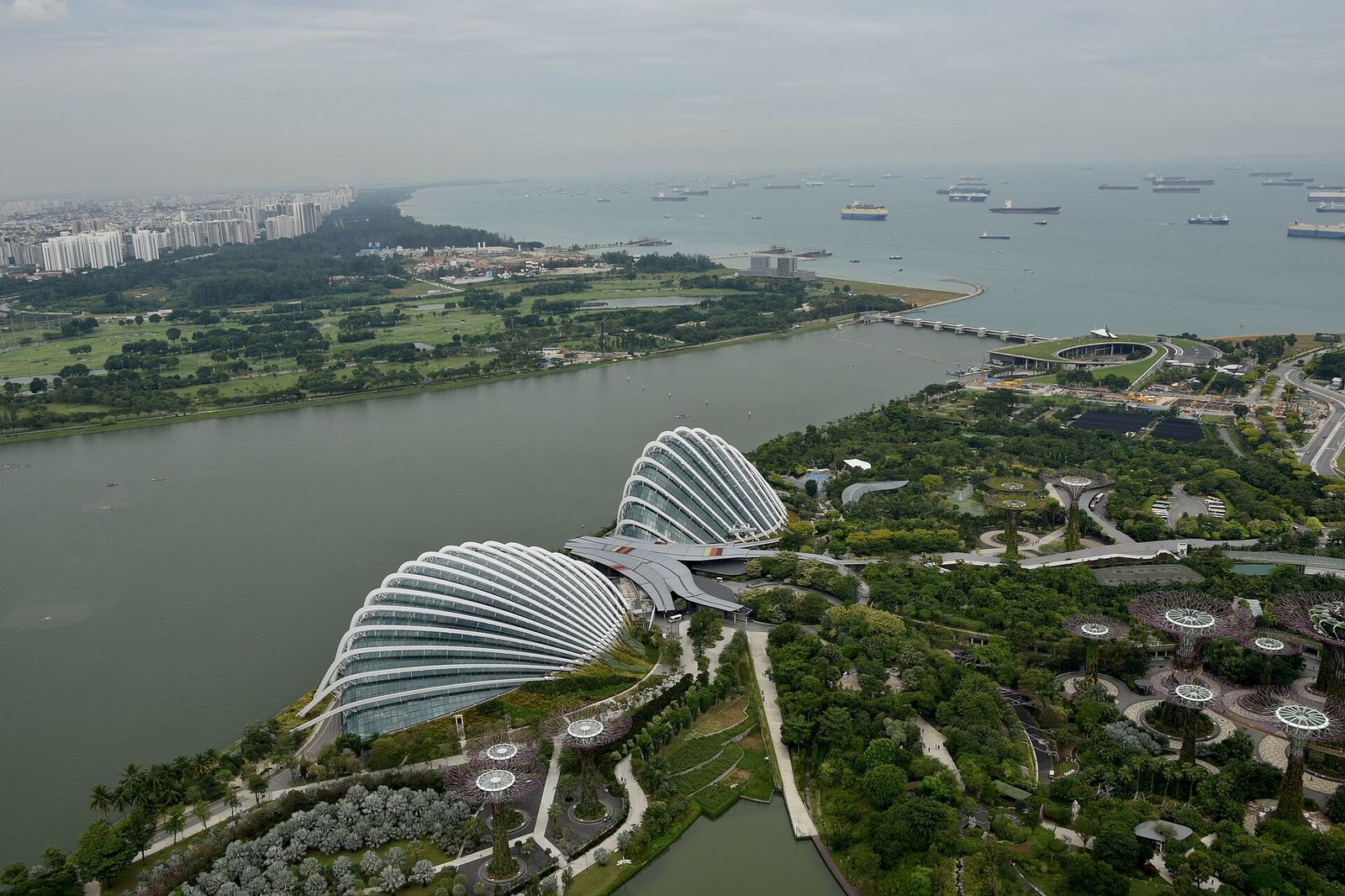 A view of the Gardens by the Bay nature park, outer harbor and ships from the 57 floor of Marina Bay Sands in Singapore, ART SG