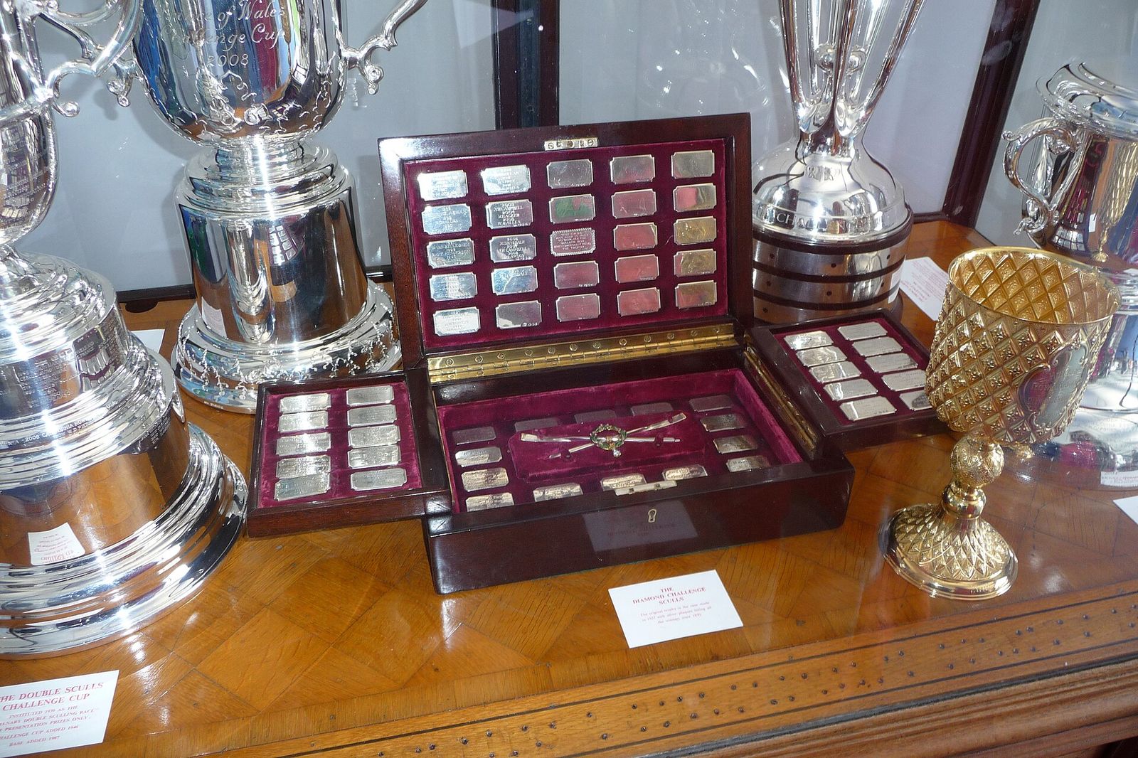 The Diamond Challenge Sculls Trophy (centre, in wooden box), photographed in the Prize Room of the Stewards Enclosure at, Henley Royal Regatta