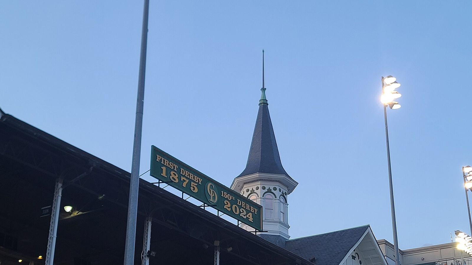 The Kentucky Derby sign for the 2024 Derby with one of the twin spires in the background
