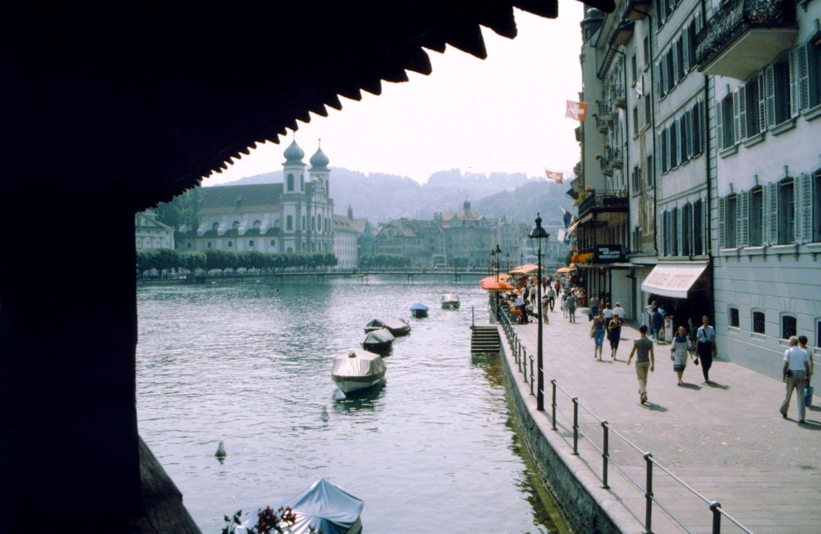Standing on the Chapel Bridge with Lake Lucerne behind, the view looks westward, downstream along the Reuss River, Lucerne Festival
