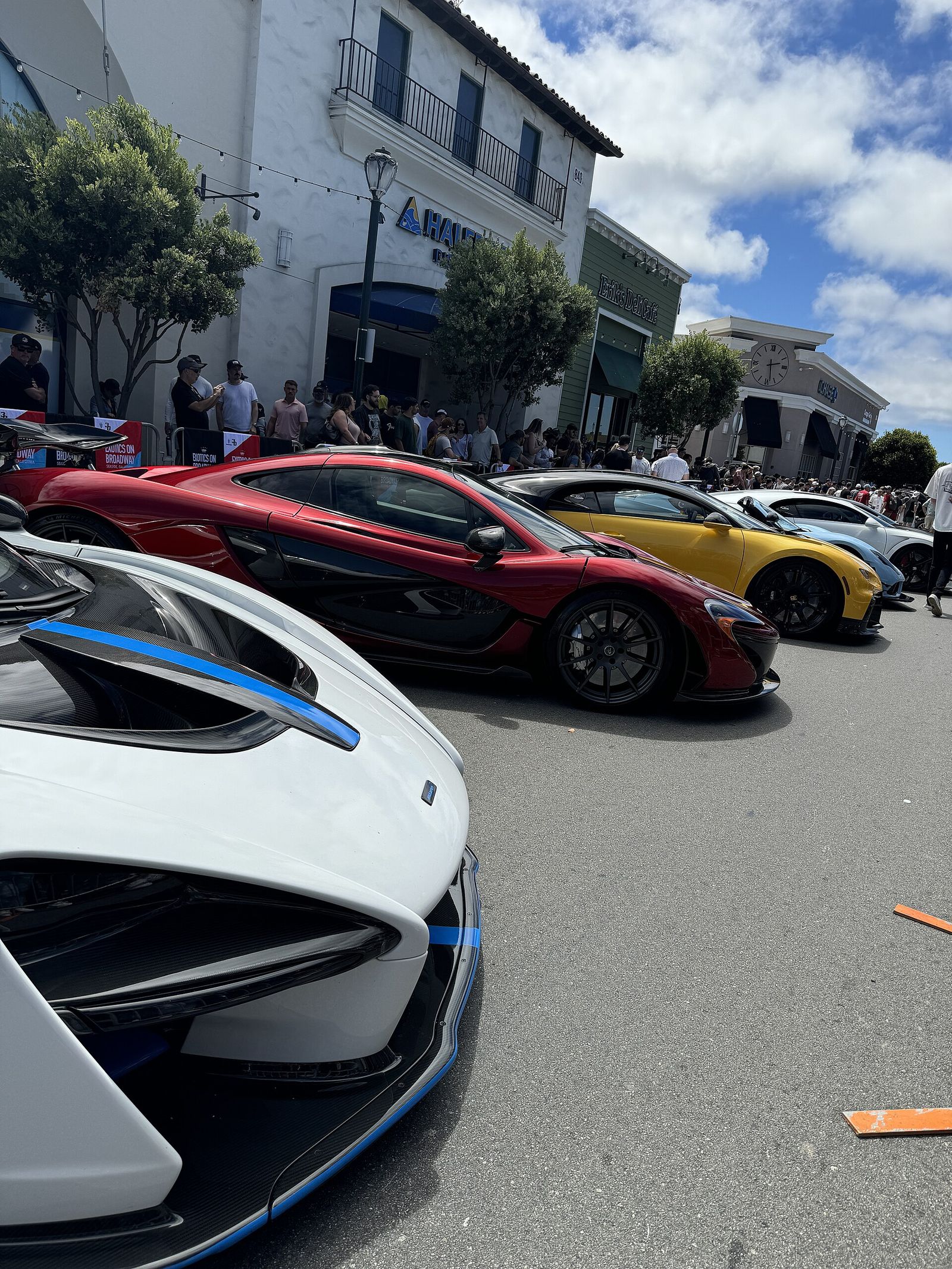 Multiple high end vehicles parked on Broadway during Monterey Car Week