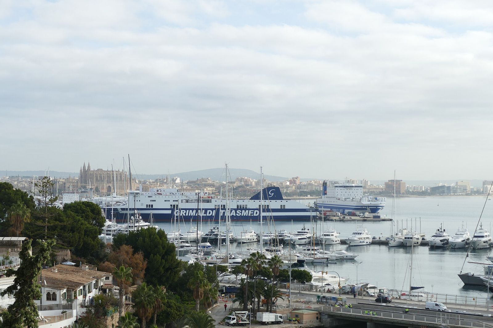 View from Parc Infantil Mirador Joan Miró in Cami del Corb Mari towards Palma de Mallorca port with Grimaldi Trasmed ship, Palma International Boat Show