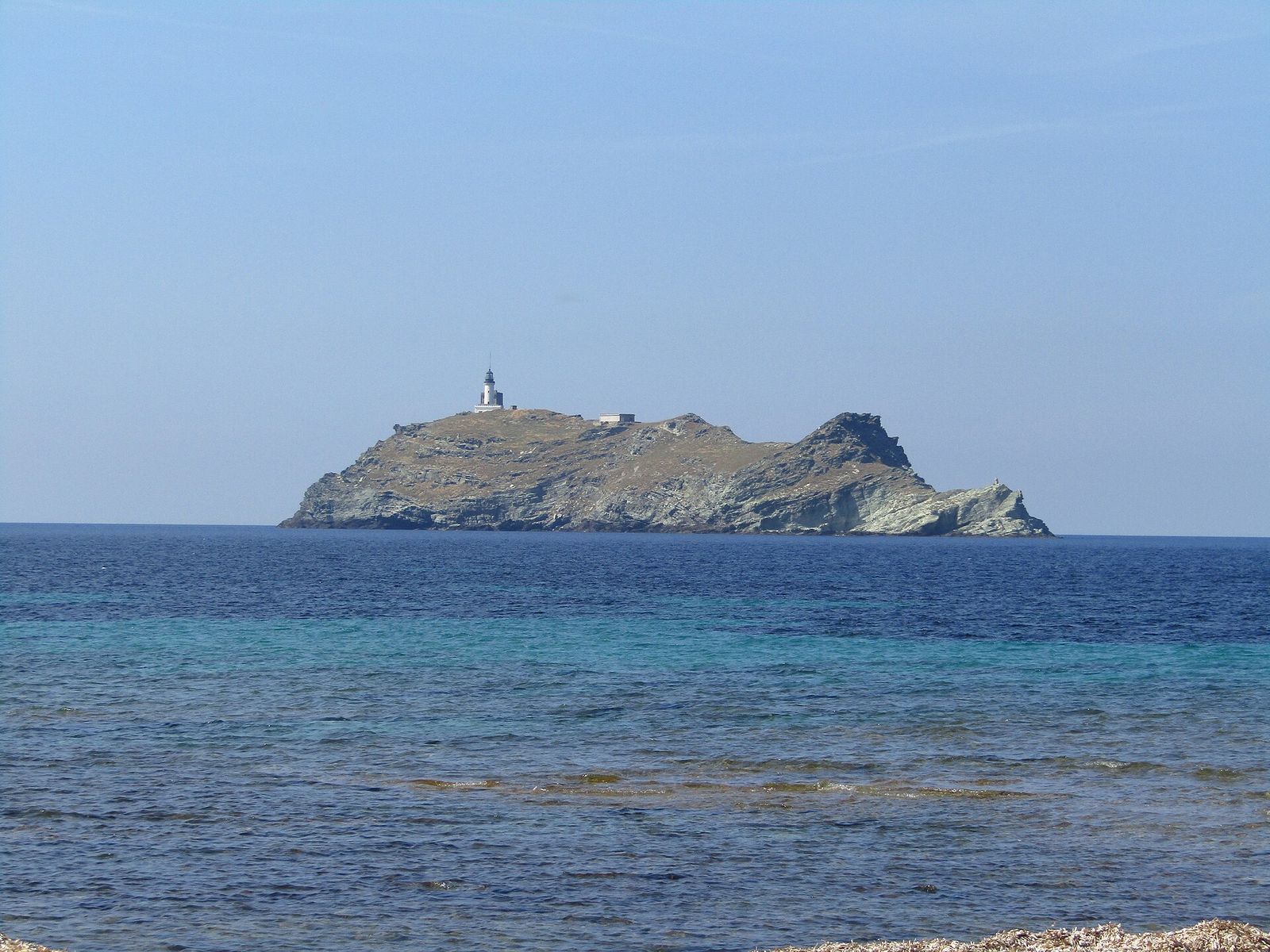A rocky island with a lighthouse on it near Cap Corse, Corsica, France, Rolex Giraglia
