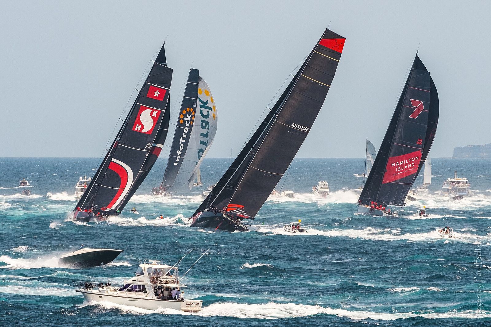 InfoTrack leads the fleet through Sydney Heads and south to Hobart in ideal, if smoky, conditions at the start of the 75th, Rolex Sydney Hobart Yacht Race