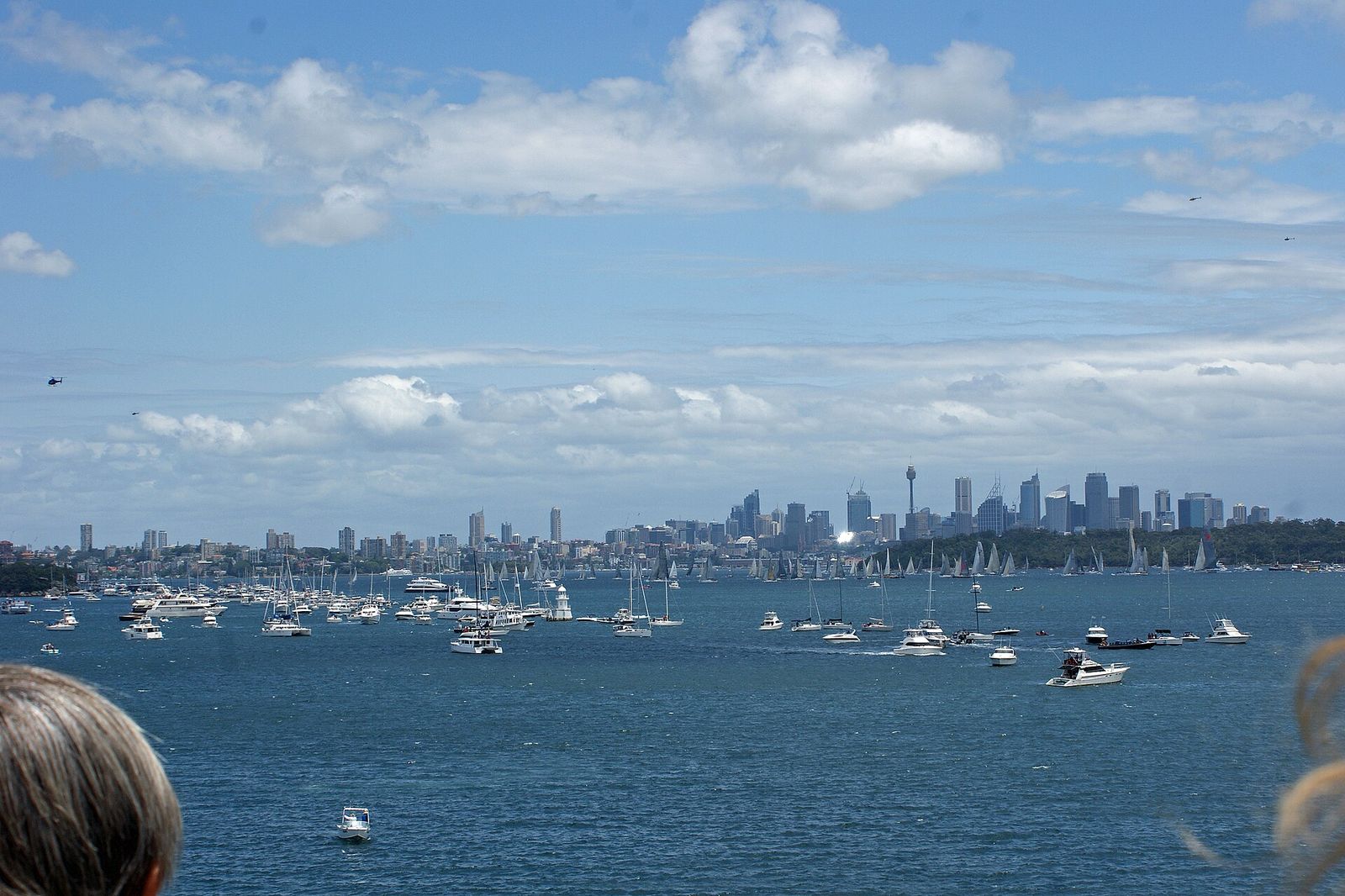 2012 Sydney to Hobart Yacht Race Yachts at the moment of the start of the race and many spectators on boats, Sydney CBD in, Rolex Sydney Hobart Yacht Race